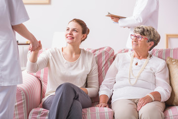 Fototapeta premium Elderly woman sitting with daughter