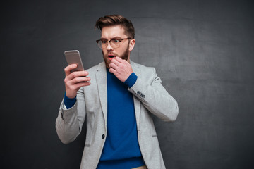 Thoughtful hipster with phone