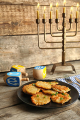 Beautiful composition for Hanukkah on table against wooden background