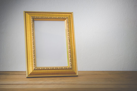 Gold Wood Photo Frame On Wooden Texture