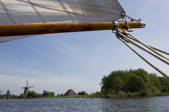 Sailing at frisian lakes. Sailing at the lake. Windmill near the lake of  Langweer. Langwarder Wieden. Friesland Netherlands. 