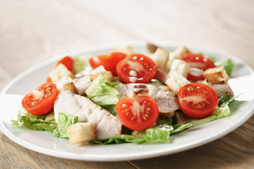 caesar salad with red cherry tomatoes, shallow focus
