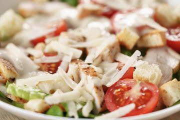 caesar salad with red cherry tomatoes, shallow focus