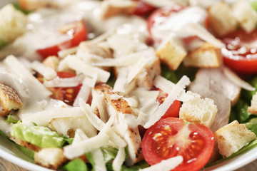 caesar salad with red cherry tomatoes, shallow focus