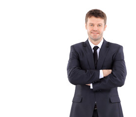 Portrait of a handsome business man  in suit smiling with arms  