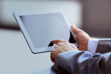 Businessman holding digital tablet in office