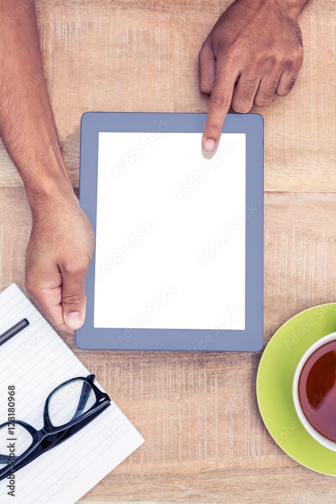 Poster cropped image of hand using on digital tablet