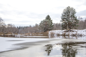 Fototapeta na wymiar A beautiful winter scenery on the banks of river