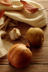 Onion, Potato and garlic on the table.