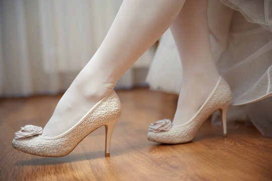 legs of bride with white stockings and white shoes