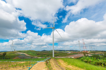 Obraz premium Huge wind turbine under clouds and blue sky, beautiful nature and Renewable power background