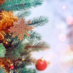 Christmas tree background and Christmas decorations with snow, blurred, sparking, glowing. Happy New Year and Xmas theme