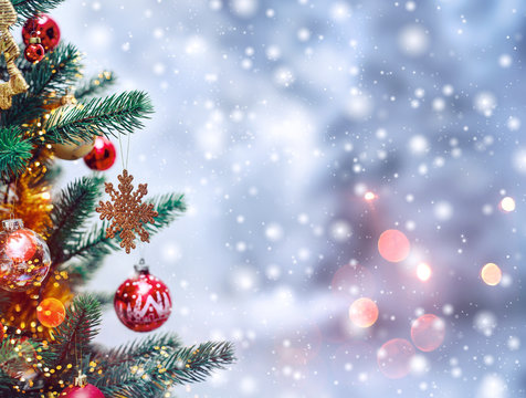 Christmas tree background and Christmas decorations with snow, blurred, sparking, glowing. Happy New Year and Xmas theme