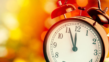 vintage alarm clock is showing midnight. It is twelve o'clock, christmas and bokeh, holiday happy new year festive concept