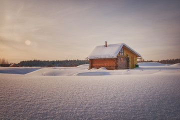 russian rural house in the winter covered with snow