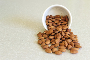 Almonds Spilling Out Of A Container, Positioned Right