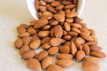 Almonds Spilling Out Of A Container, Close Centered