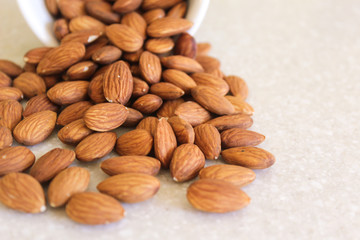 Almonds Spilling Out Of Container, Positioned Close Off Left Edg