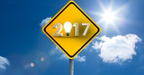 2017 road sign against a composite image of clouds and sky