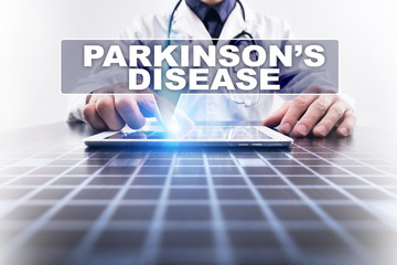 Medical doctor working with modern computer and selecting parkinson's disease. Medical concept.