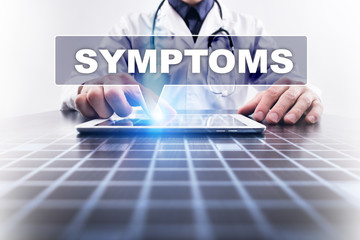 Medical doctor working with modern computer and selecting symptoms. Medical concept.
