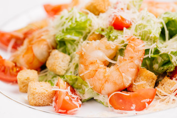 seafood caesar salad with shrimps, salad leaf, parmesan cheese 