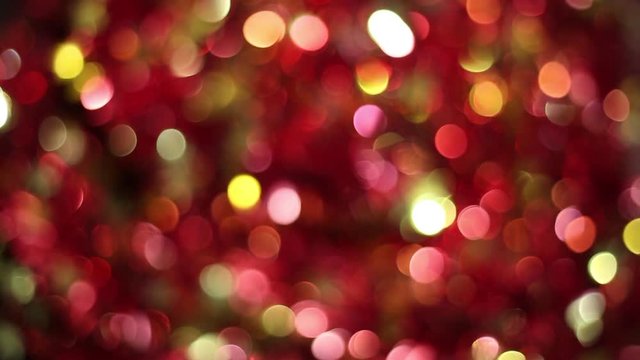 Beautiful out of focus round lights background of red, orange, yellow, golden, pink and black colors. Real time full hd video footage.
