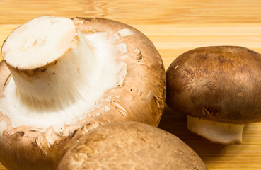 mushroom champignons on a wooden Board