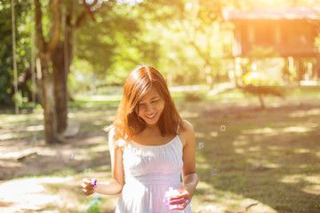 a beautiful woman blowing bubbles