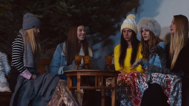 Happy female friends meeting and drinking hot beverages outdoors. 60 FPS slow motion, 4K UHD RAW edited footage