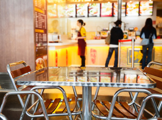 Seats and table at a fast food cafe - obrazy, fototapety, plakaty