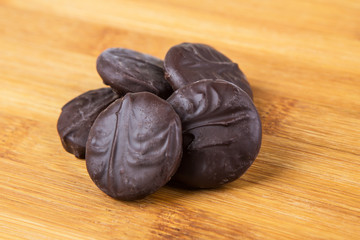 Peppermint mints covered in chocolate isolated on wood background
