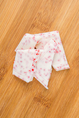Peppermint white chocolate bark isolated on wood background