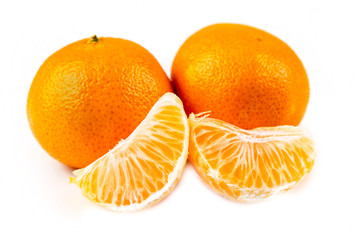 Three navel oranges one peeled two unpeeled isolated on white background