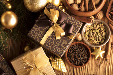 Christmas theme. Presents on a wooden table. Golden and brownish aesthetics.