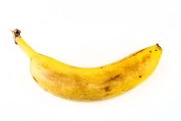 One old yellow banana isolated on white background