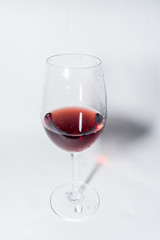 Red vine in a glass on white background