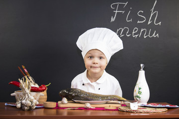 funny boy chef prepares fish