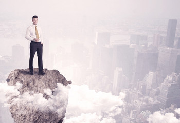 Winner business person standing on rock