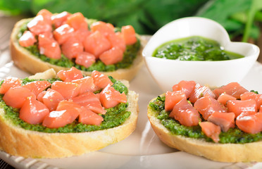 Bruschetta with fresh salmon and pesto sauce