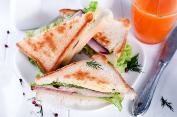 breakfast with club sandwich and juice