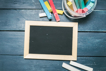 Small blackboard on old wood background