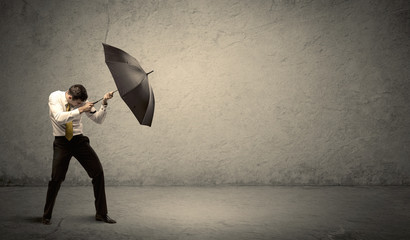 Handsome business man holding umbrella with copy space backgroun