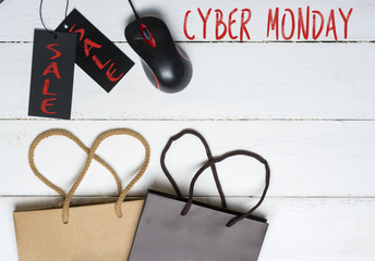 shopper with cyber monday paperbag, PC mouse, laptop. ticket label Sale tag - online shopping concept 