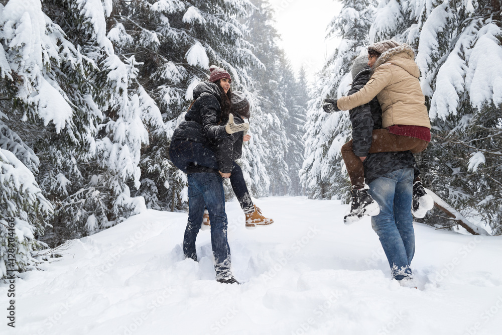 Wall mural Friends Group Two Playful Couple Snow Forest Young People Outdoor Winter Pine Woods