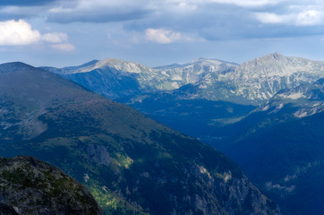 Fototapeta premium Blue mountains with clouds and shadows