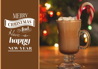 Composite image of merry christmas wishes and a cup of hot choco