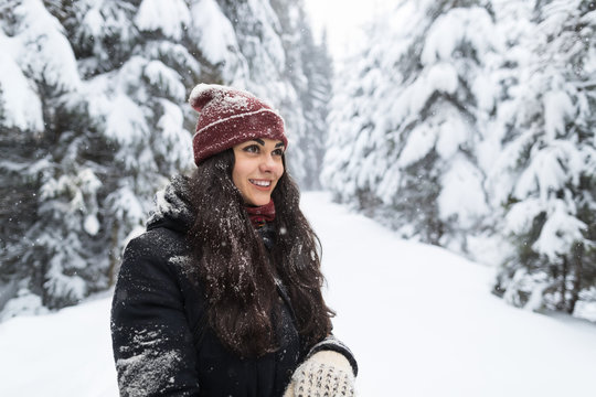 Young Beautiful Woman In Winter Snow Forest Girl Outdoors Walking Snowy White Park Wear Warm Clothes