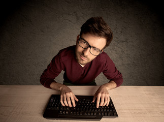 Computer geek typing on keyboard