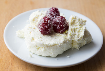 Cottage cheese in plate with berries